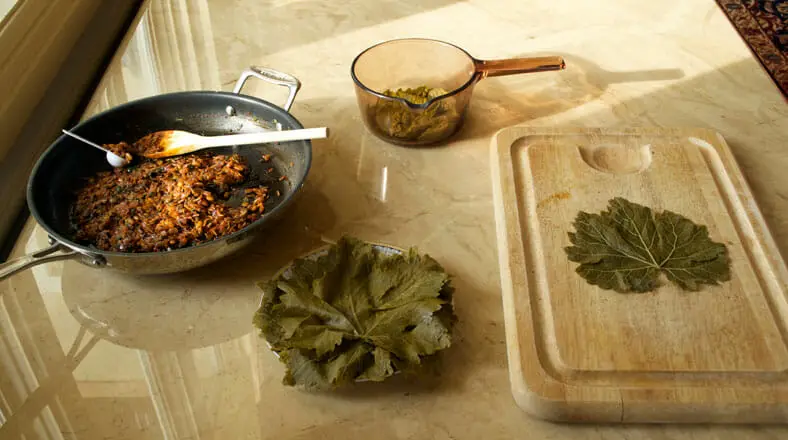 Grape leaves with stuffing on wooden tray