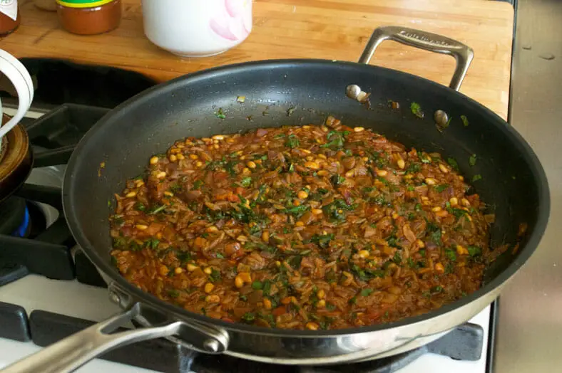 Preparing stuffing for the dish in a pan