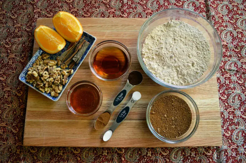View of ingredients - flour, vanilla extract, honey, walnuts, oranges, brown sugar