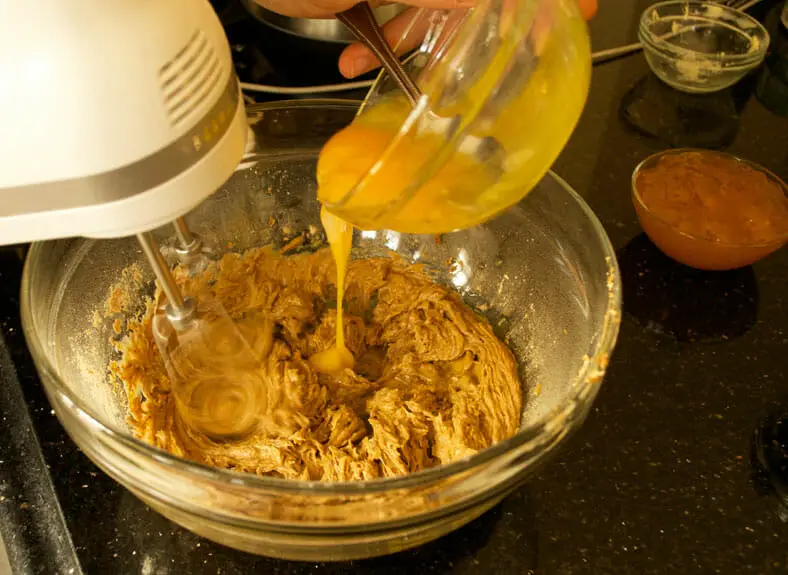 Adding egg to whisking bowl with dry ingredients