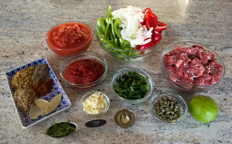 Ingredients - beef, bell peppers, onions, lemon, garlic, spices, tomato paste, dried thyme, dried oregano, dill