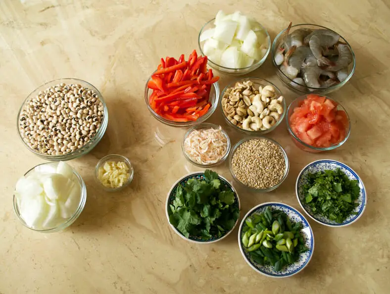 View of ingredients - shrimps, cashew, peanuts, spring onions, sesame seeds, tomatoes, onions, garlic