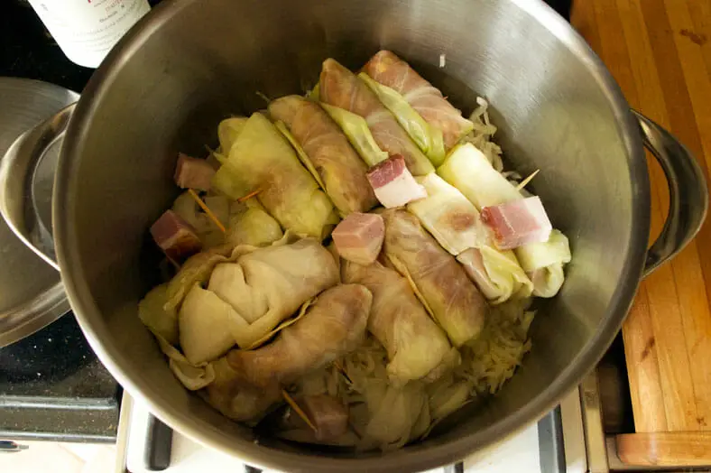 Cooking cabbage stuffed meat rolls in stockpot