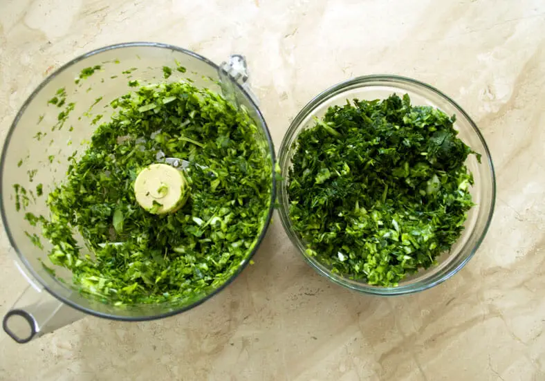 Mixture of parsley, mint, coriander, spring onions in a blender