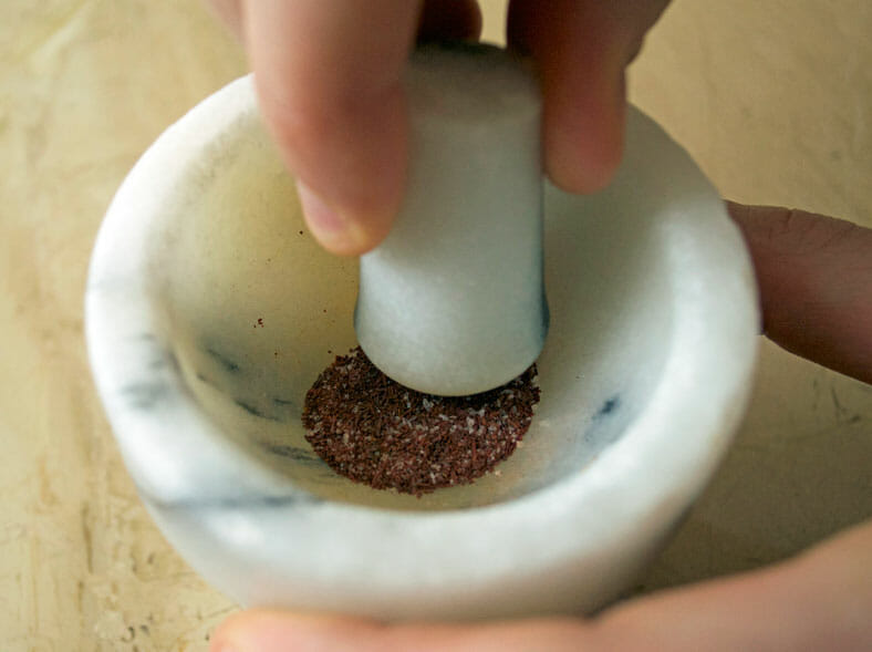 Grinding of spice in mortar and pestle