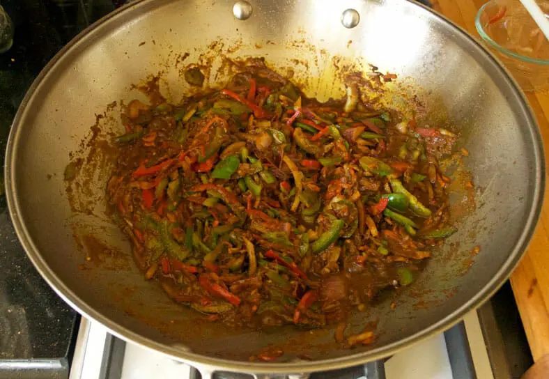 Mixing paste with the added vegetables and cooking it properly