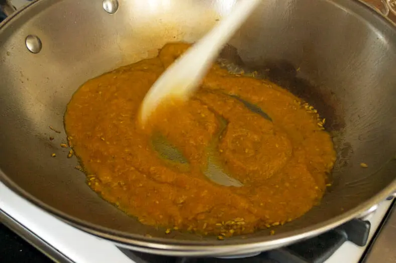 Cooking paste in wok till thickens