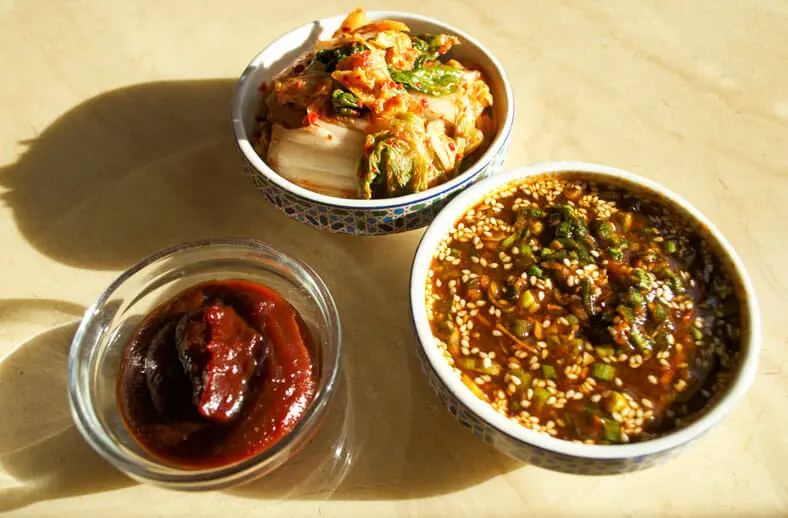Variety of sauces for the dish - chili pepper and soybeans sauce, cavenne sauce, kimchi