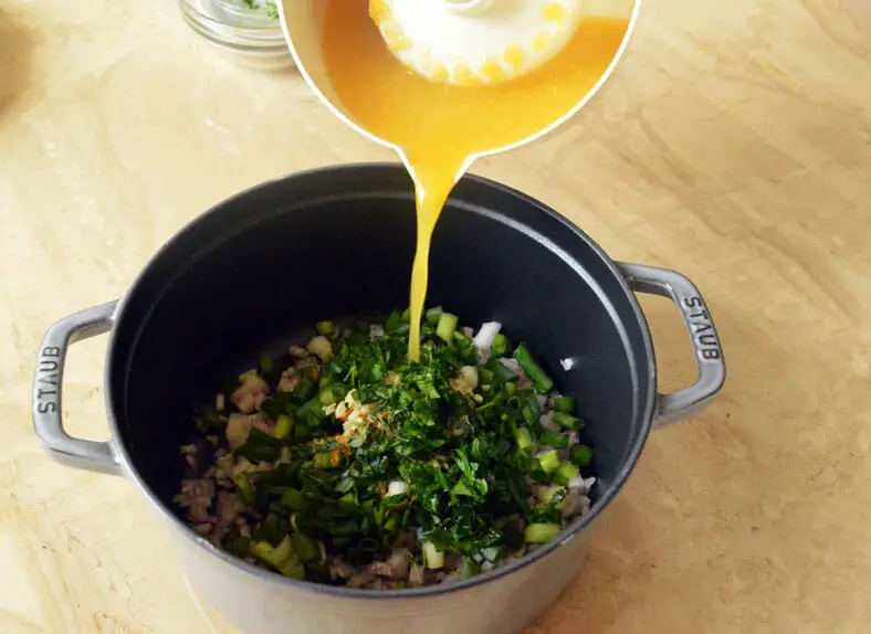 Adding orange juice in a pan