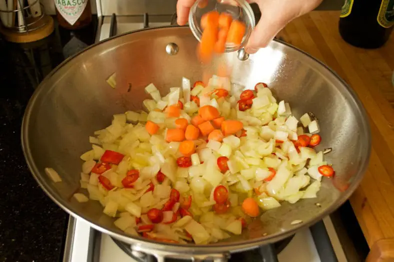 Adding carrots to the wok