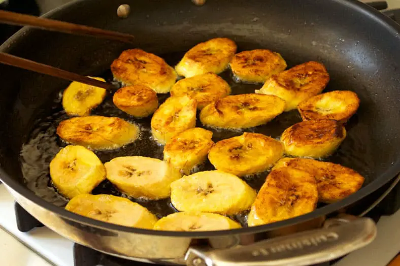 Flipping plantains to cook it on both sides