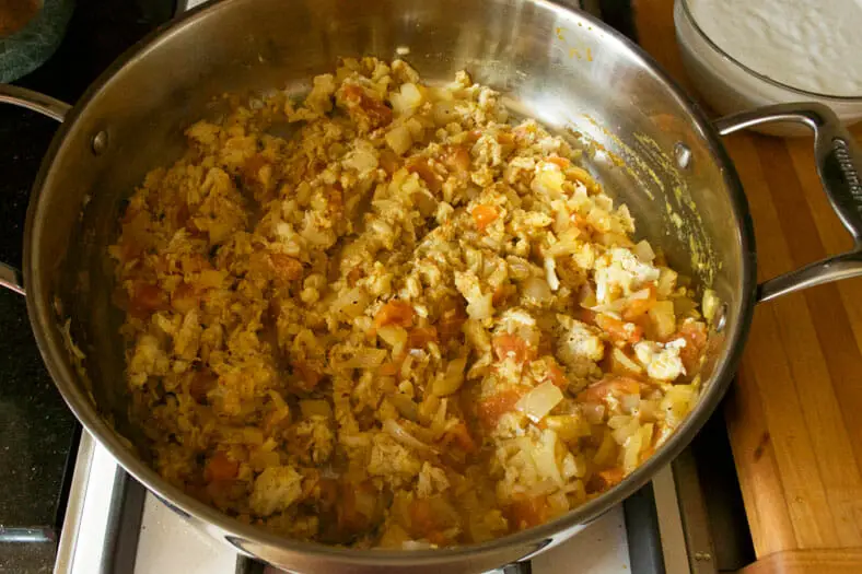 All the ingredients - crab meat, onions, tomatoes and spices - finishing cooking for Mozambique Caril de Caranguejo (Crab Curry)