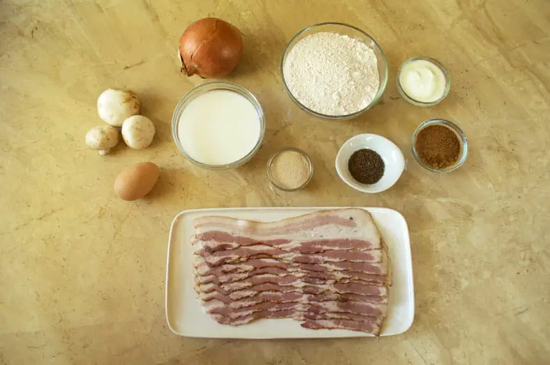 View of ingredients - bacon, eggs, flour, mushrooms, onions, yeast