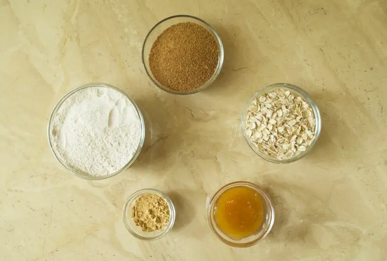 View of ingredients - oats, sugar, honey, flour, coconut oil