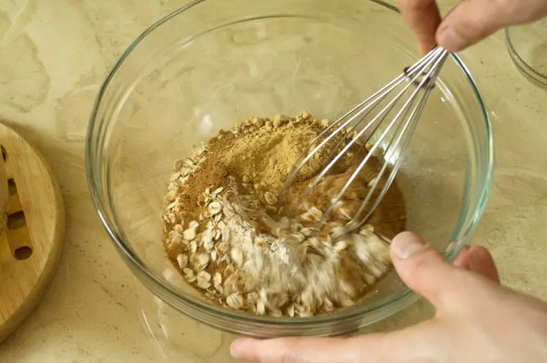 Whisking dry ingredients together for New Zealand Anzac Biscuit