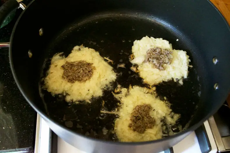 Cooking pancake in hot pan till golden brown on 1 end