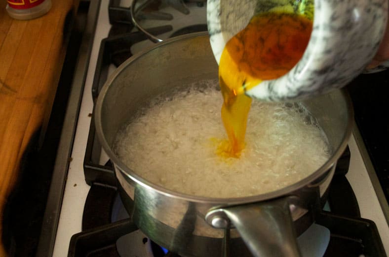 Adding saffron to rice that will be served with Jordanian Mansaf