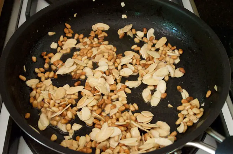 Roasting pine nuts and almonds for the dish