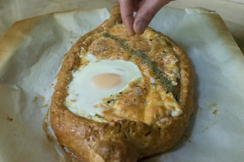 Fully baked cheese bread with egg on top