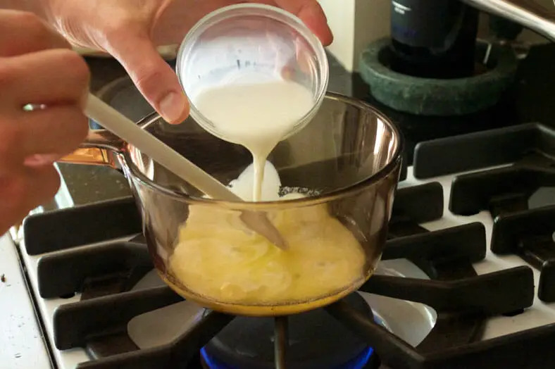 Mixing milk to the melted butter for dip sauce