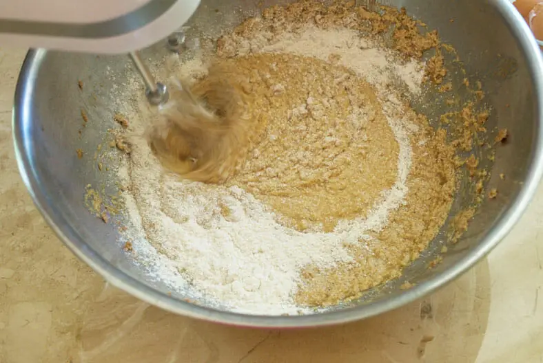 Adding flour to the egg, butter and sugar mix
