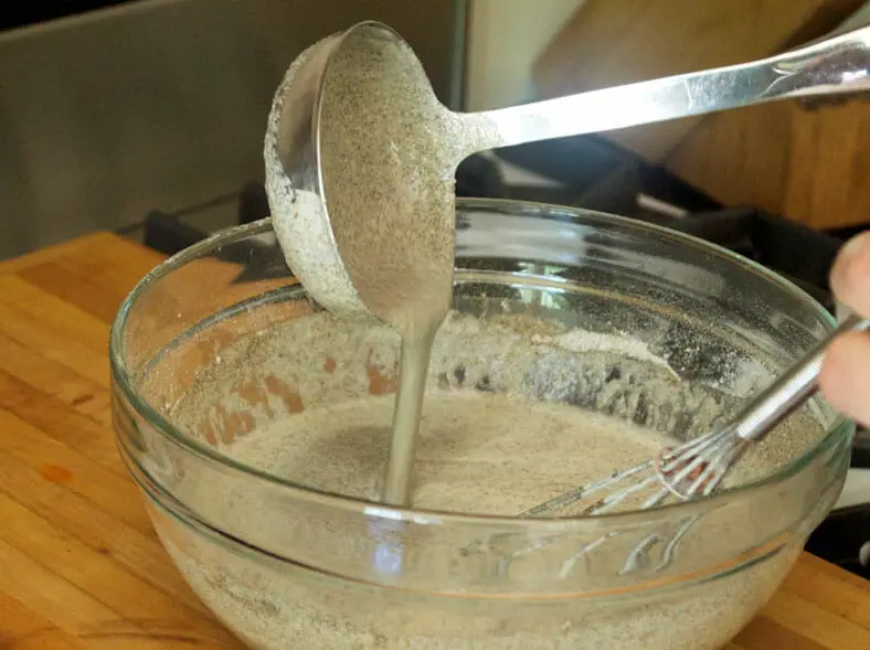 Mixing batter of eggs, milk, flour till slightly runny consistency