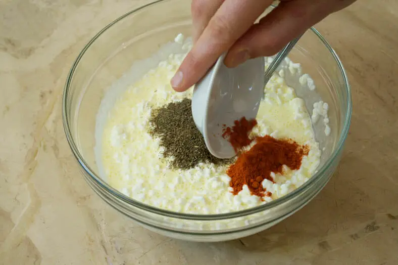 Mixing ingredients (eggs, milk, herbs, scallions, cottage cheese) for the cheesy filling of nalysnyky (Ukranian crepe)