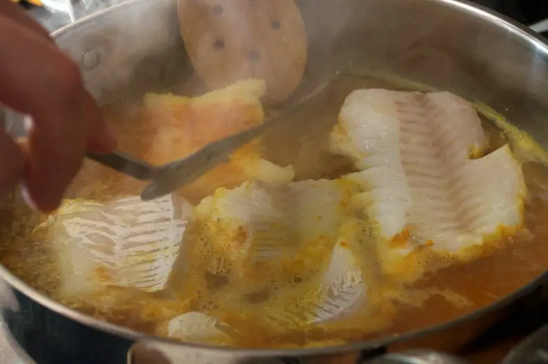 As the fish cooks, you flip to cook both sides before removing from heat.