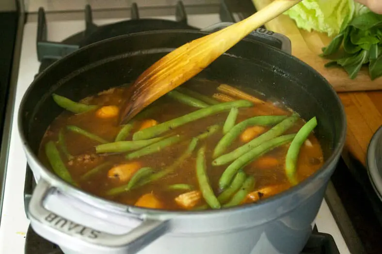 Adding green beans to the beef stew