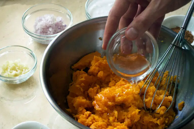 Add coconut oil into the scooped sweet potato