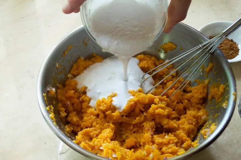 Add coconut milk into the scooped sweet potato