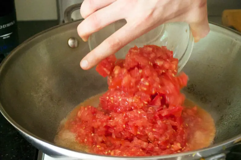 Starting to sauté freshly peeled and diced tomatoes