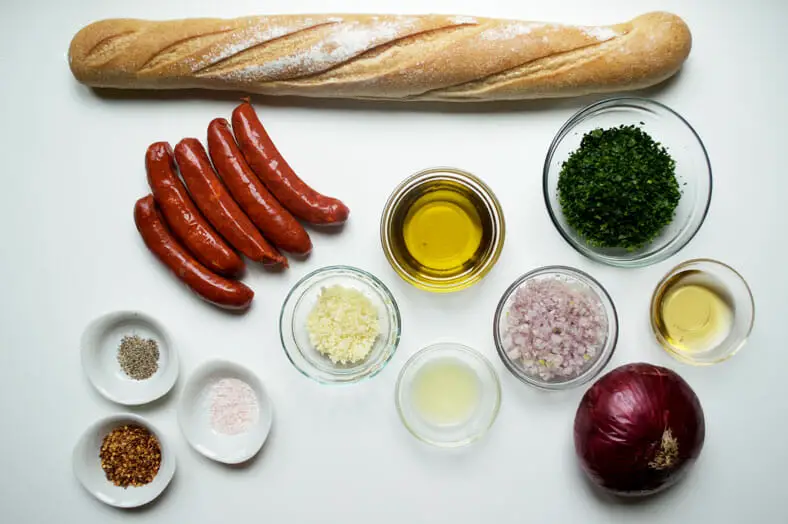 Here are all the ingredients you need to make choripan and fresh chimichurri. Choripan is a staple of Argentinian cuisine, often sold as street food. It’s essentially a grilled chorizo sausage inside a toasted baguette topped with a dollop of chimichurri.