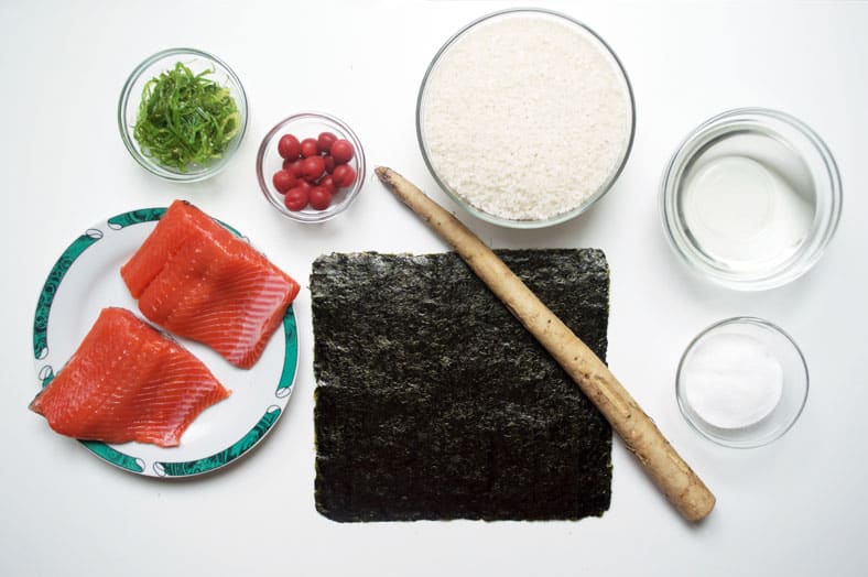 View of ingredients - rice, seaweed sheet, salmon fillet, rice wine vinegar, sugar, water
