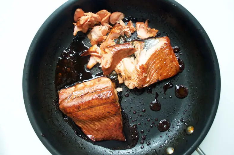 As another filling for our Japanese onigiri, or rice cakes, we made a quick salmon teriyaki. After a minute of initial searing, pour in your teriyaki sauce over the salmon, and mix around to integrate the sauce into the salmon.