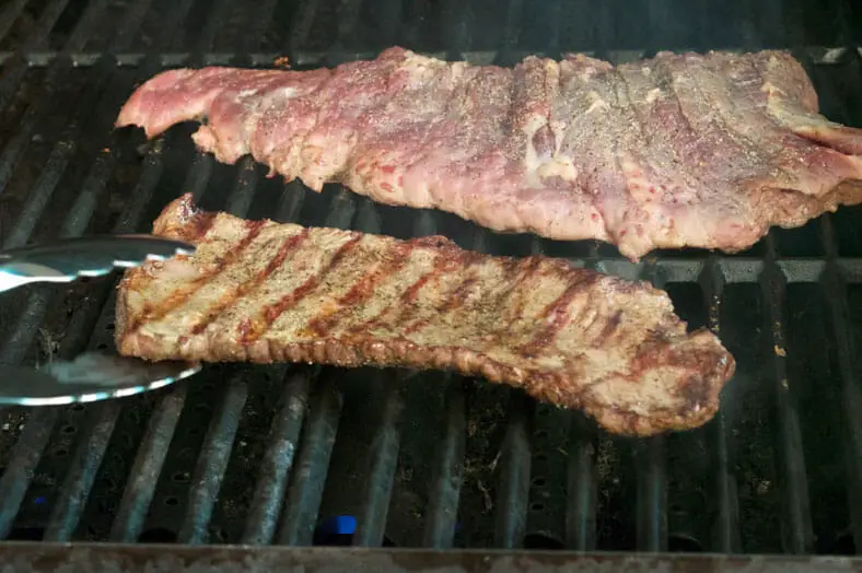 To make a Chivito, the Uruguayan Meat Sandwich, you want to start by preparing and grilling your meat. Here we are grilling skirt steak for about 3 minutes on each side