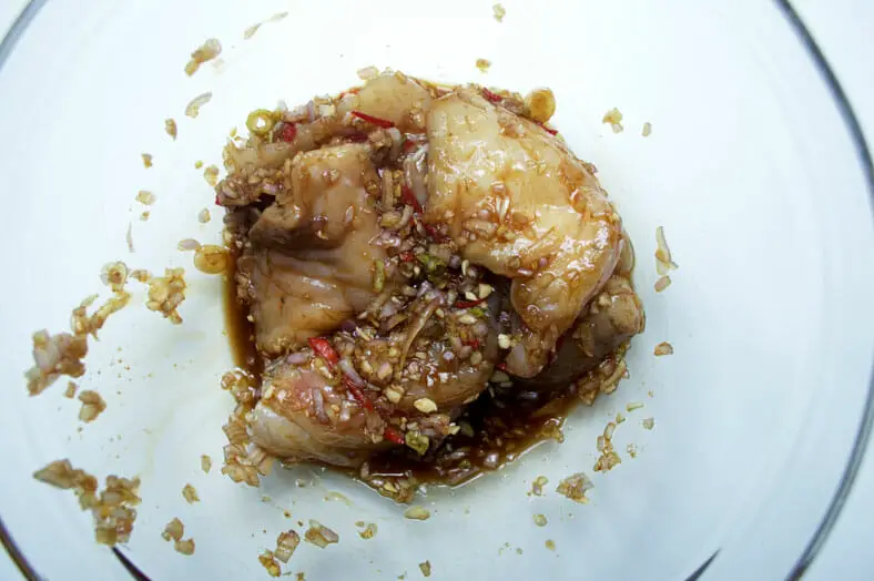To make Ca Kho To, a Vietnamese caramelized fish stew, you start with creating a marinade for your fish consisting of shallots, garlic, green onion, chilis, sugar and fish sauce
