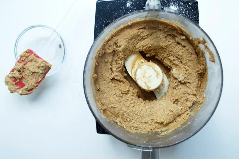 To make Norwegian Sandkaker, a Christmastime almond buttery wafer like cookie, you start by pulsing together your butter and pastry flour. Then, add your almond meal, followed by your egg and coconut sugar, and blend, to form a sticky dough.