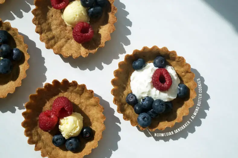 The is a special Norwegian christmas time almond and butter cookie or wafer. They are a wonderful treat to accompany tea or coffee and can be served plain or dressed with any number of toppings. We liked ours with coconut whipped cream and fresh berries!