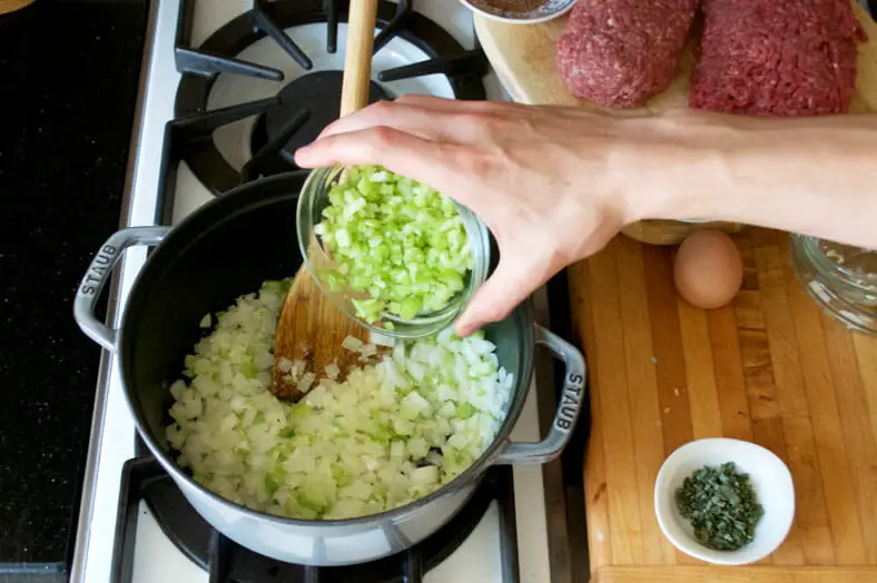 Step 1 to preparing the meat filling is sautéing garlic, onions and celery together until translucent