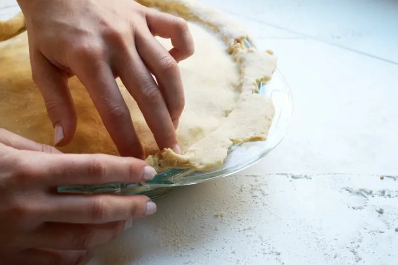 Closing up pie crust tightly with hands
