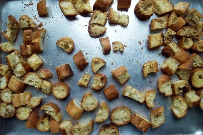 Baking croutons coated with spices in a tray