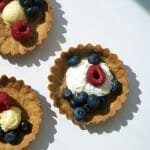 Baked cookie with raspberry and blueberry toppings