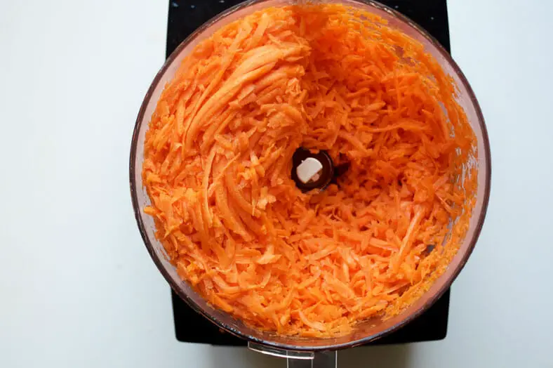 There are a lot of carrots used in halva ye havij (Persian sweet carrot confection). One of the easiest ways to grate them quickly is to use a food processor. Trust us!