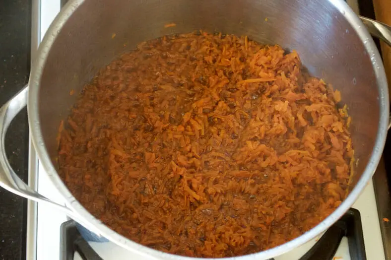 Letting grated carrots cook and soften in dissolved sugar water