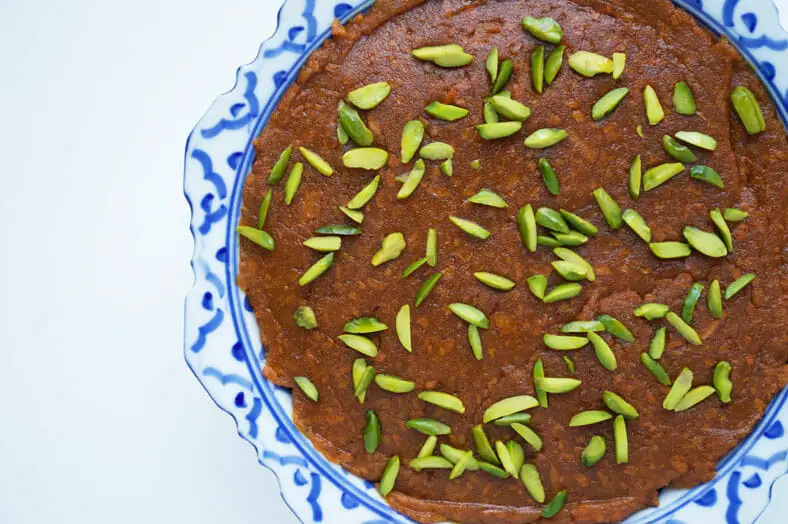 When you've spread your halva ye havij (Persian sweet carrot confection), place some crushed pistachios on top then let it cool
