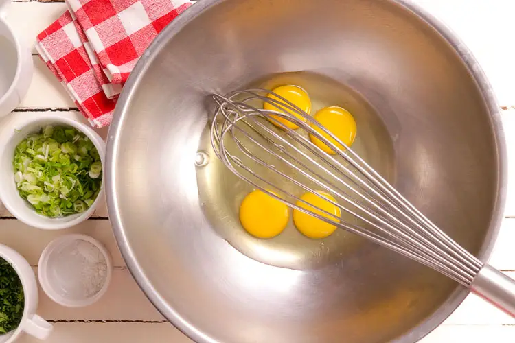 Create a wet mixture of eggs and green onions