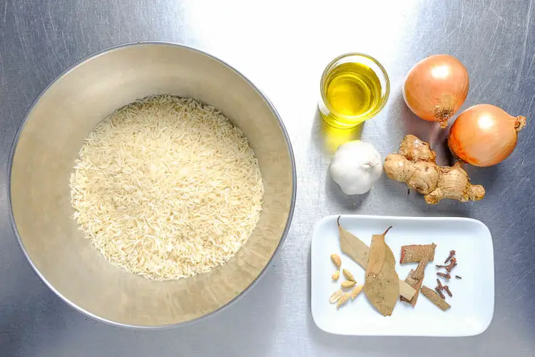 View of ingredients - basmati rice, onion, garlic, ginger, bay leaves, cloves