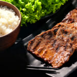 Korean Beef Bulgogi grilled on a plate with a bowl of white rice