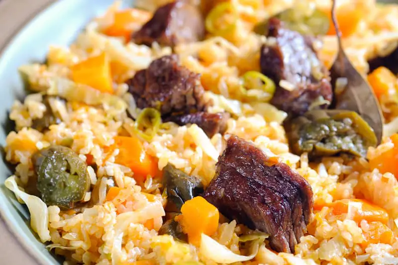 Fried vegetable rice with meat in a serving plate